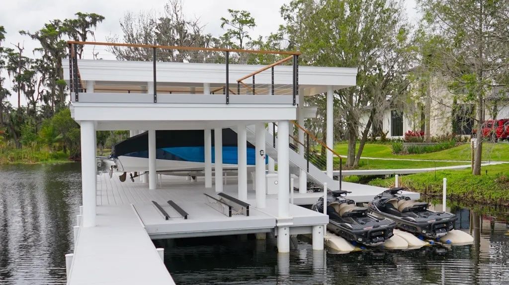 All-composite white boathouse with an upper deck, boat slip and jet ski ports