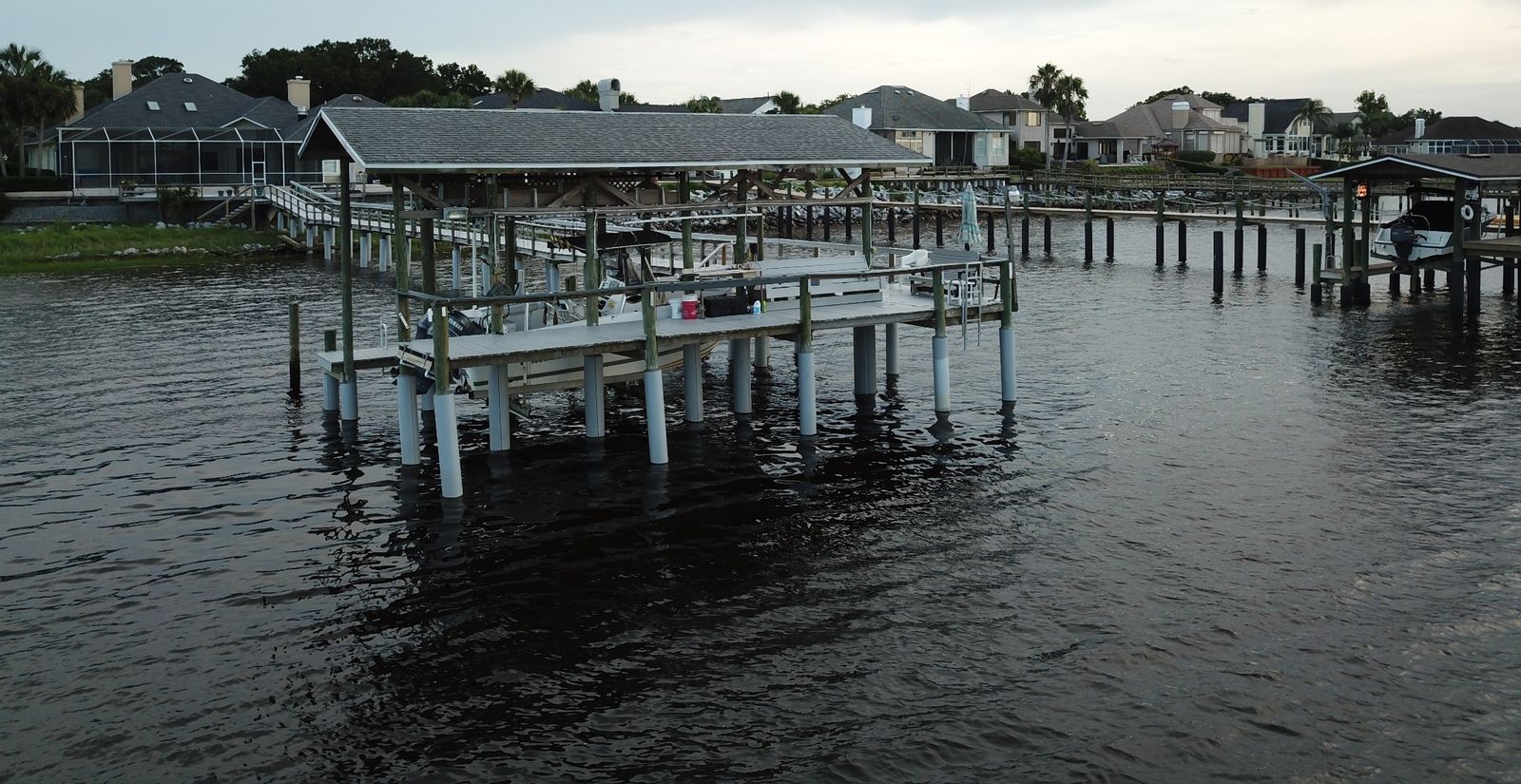 Boathouse and walkway with protected pilings