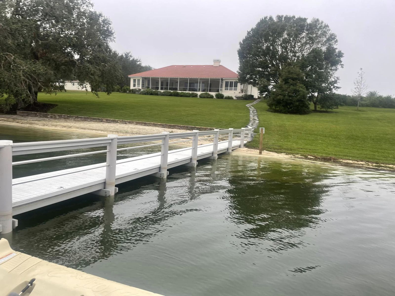 Composite walkway with aluminum rail running to the shore