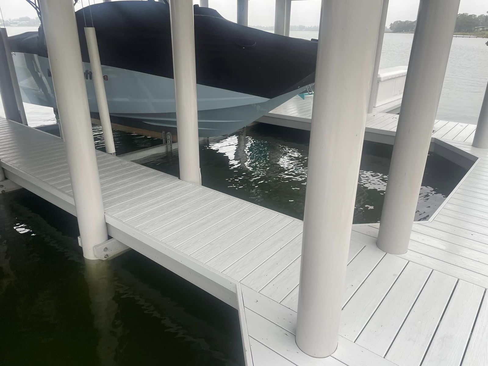 Boat on a lift inside a composite boathouse